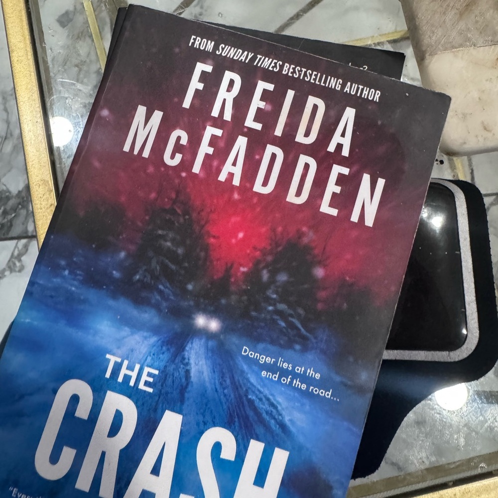 Freida McFadden "The Crash" Paperback Book - Blue & Red Cover